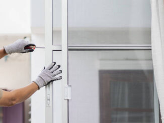 Construction worker repairing the sliding window.