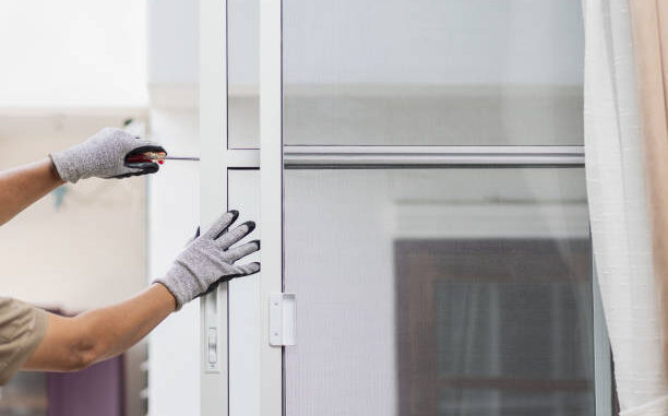 Construction worker repairing the sliding window.